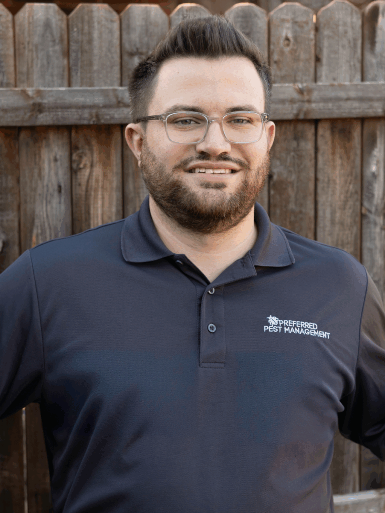 preferred pest management pest control technician providing wasp removal in the yard of a home in plano, tx