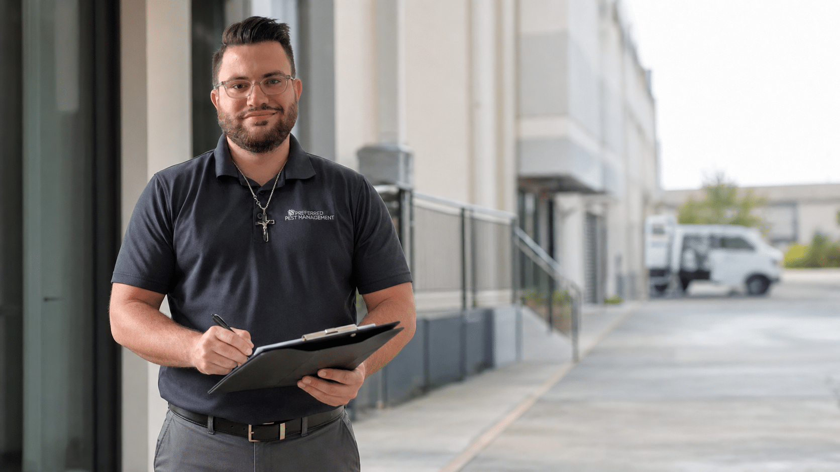 Preferred Pest Management technician reviewing a commercial pest inspection checklist at a North Texas business