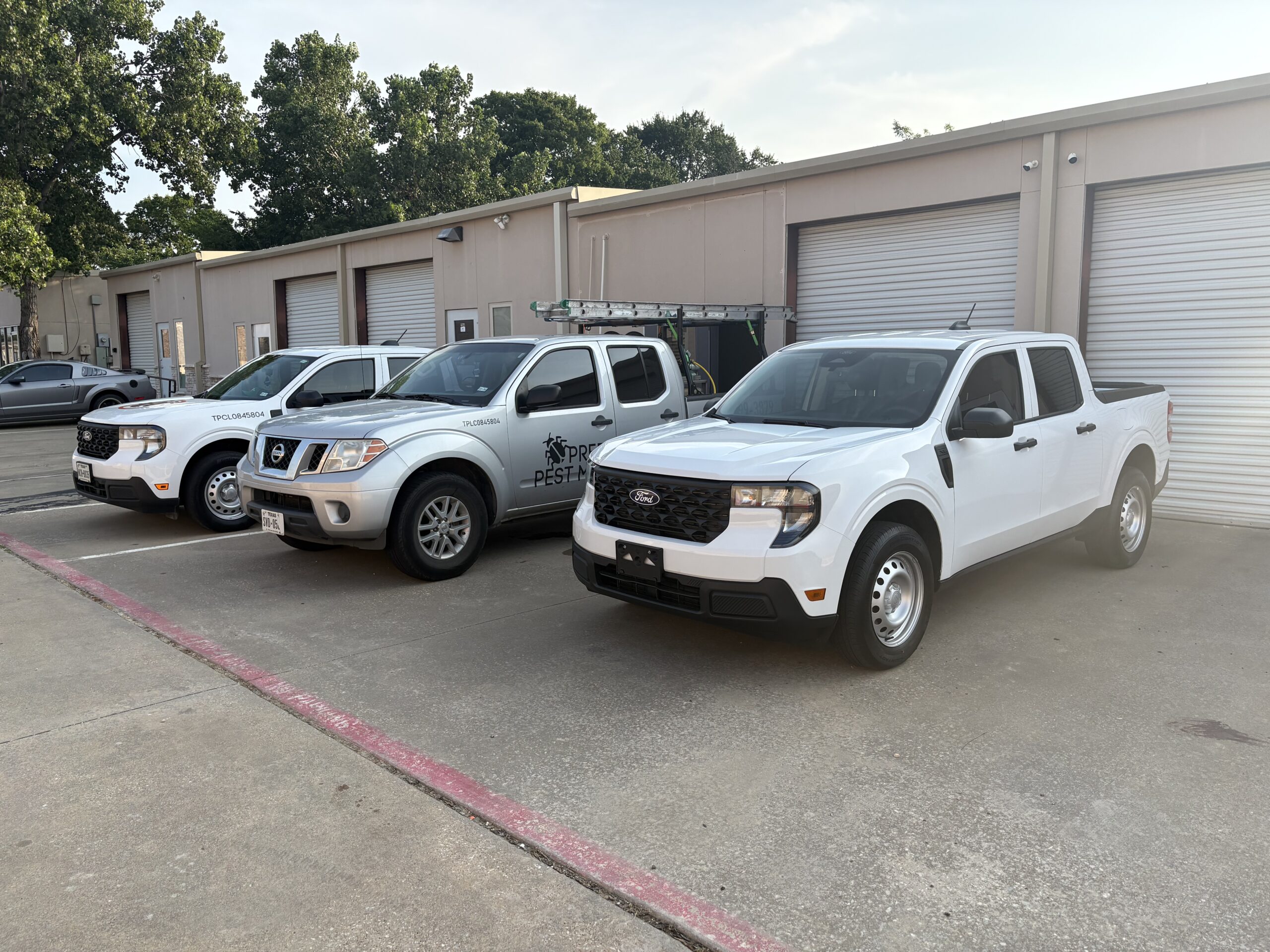 Preferred Pest Management service trucks parked outside the Sachse, Texas office